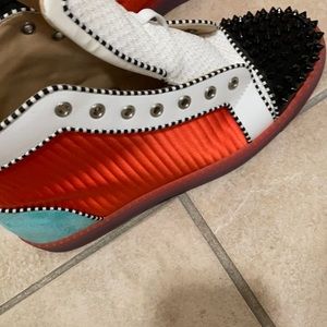 White and black and orange and green Red Bottoms.